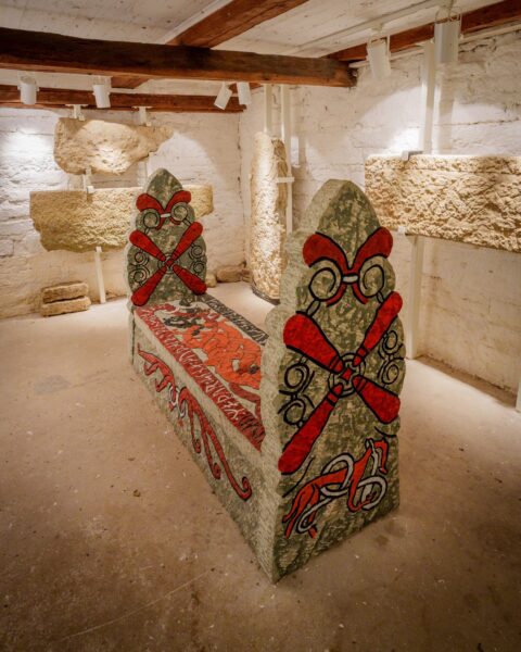 Vikingatida stensarkofag med målade röda och svarta ornament i Örberga stenmuseum, Vadstena kommun, Östergötland